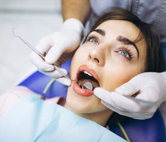 Girl getting her teeth checked by dentist in Whitby.